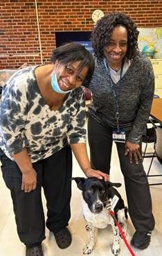 Case Manager Beverly Bradley (left) and Barbara Dorsey (right) standing next to Norman at Hall-Mercer Community Mental Health Center.